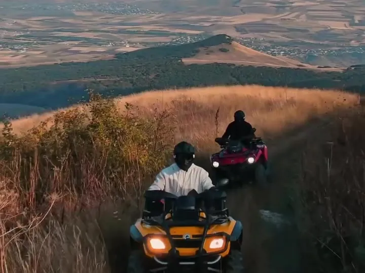 ATVs on a ridge above the valley