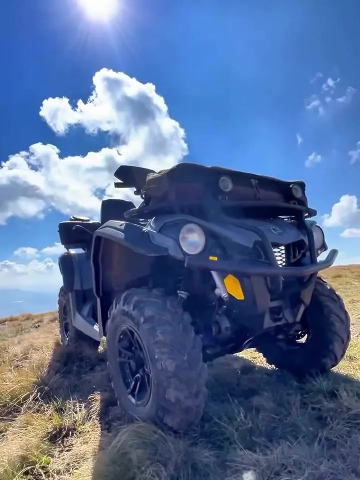 ATV on a mountaintop under a blue sky